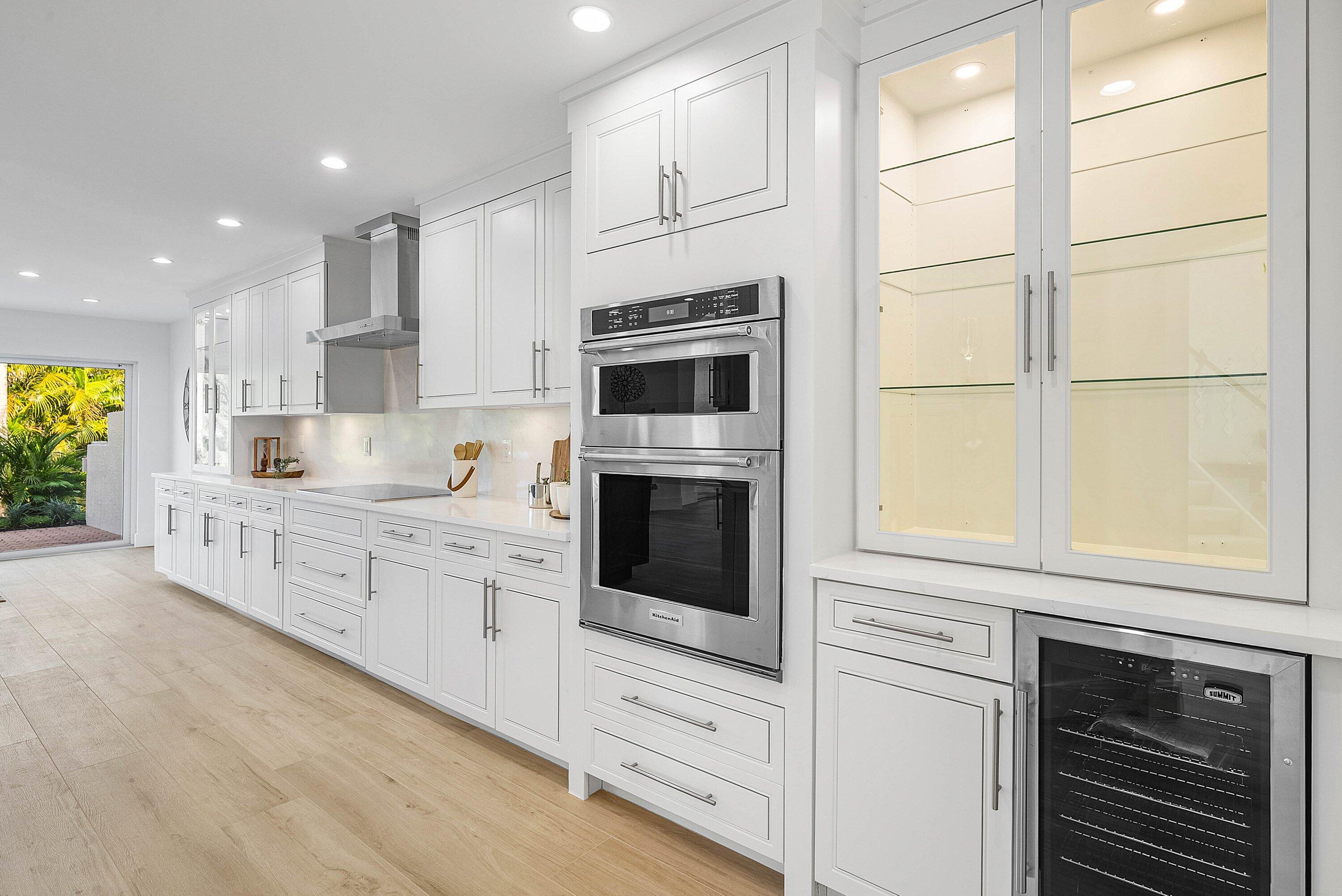 5174 Windsor Parke Drive Boca Raton, FL 33496 - Photo 5 of 55 a kitchen with granite countertop white cabinets and stainless steel appliances
