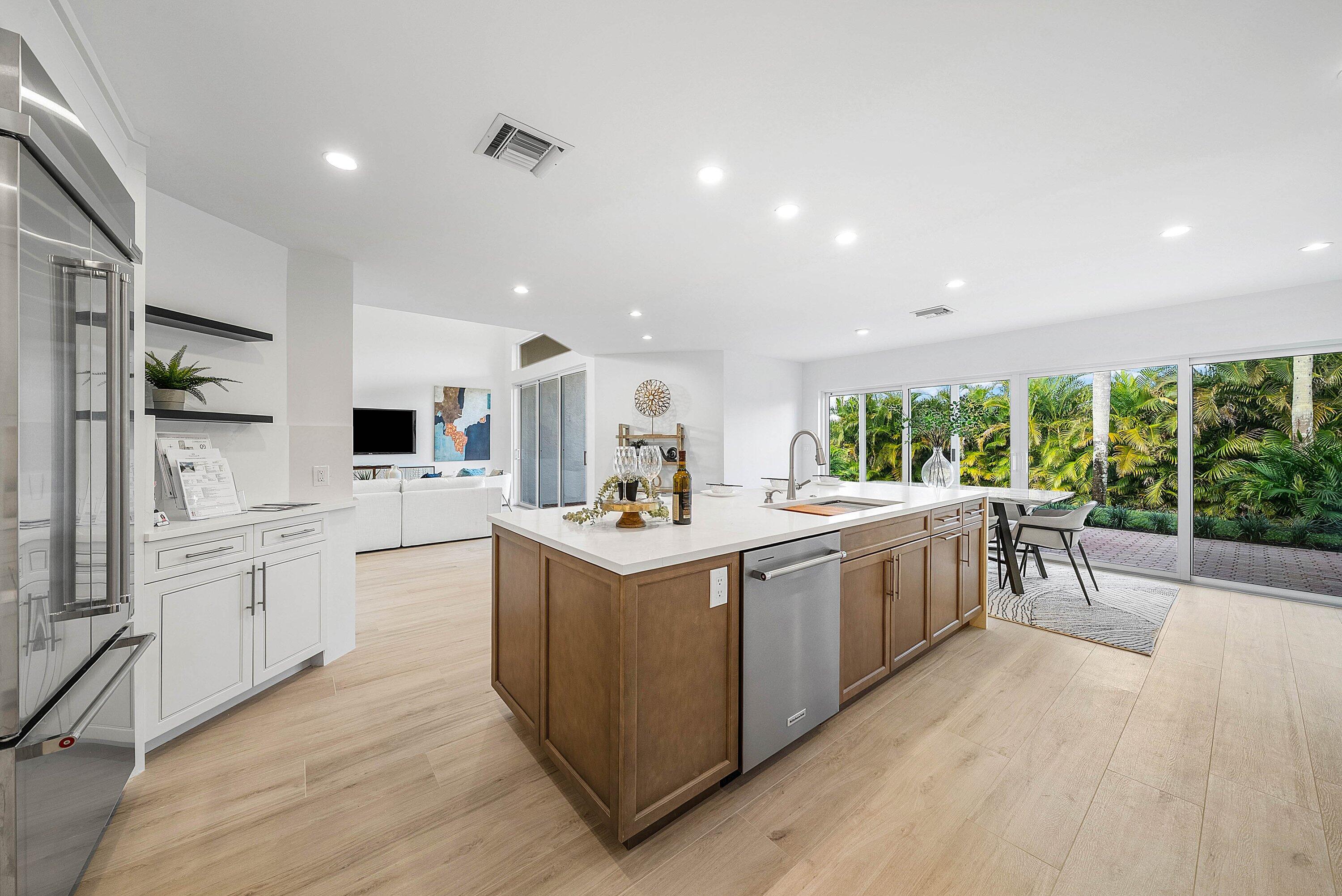 5174 Windsor Parke Drive Boca Raton, FL 33496 - Photo 7 of 55 a kitchen with stainless steel appliances granite countertop a stove and a sink