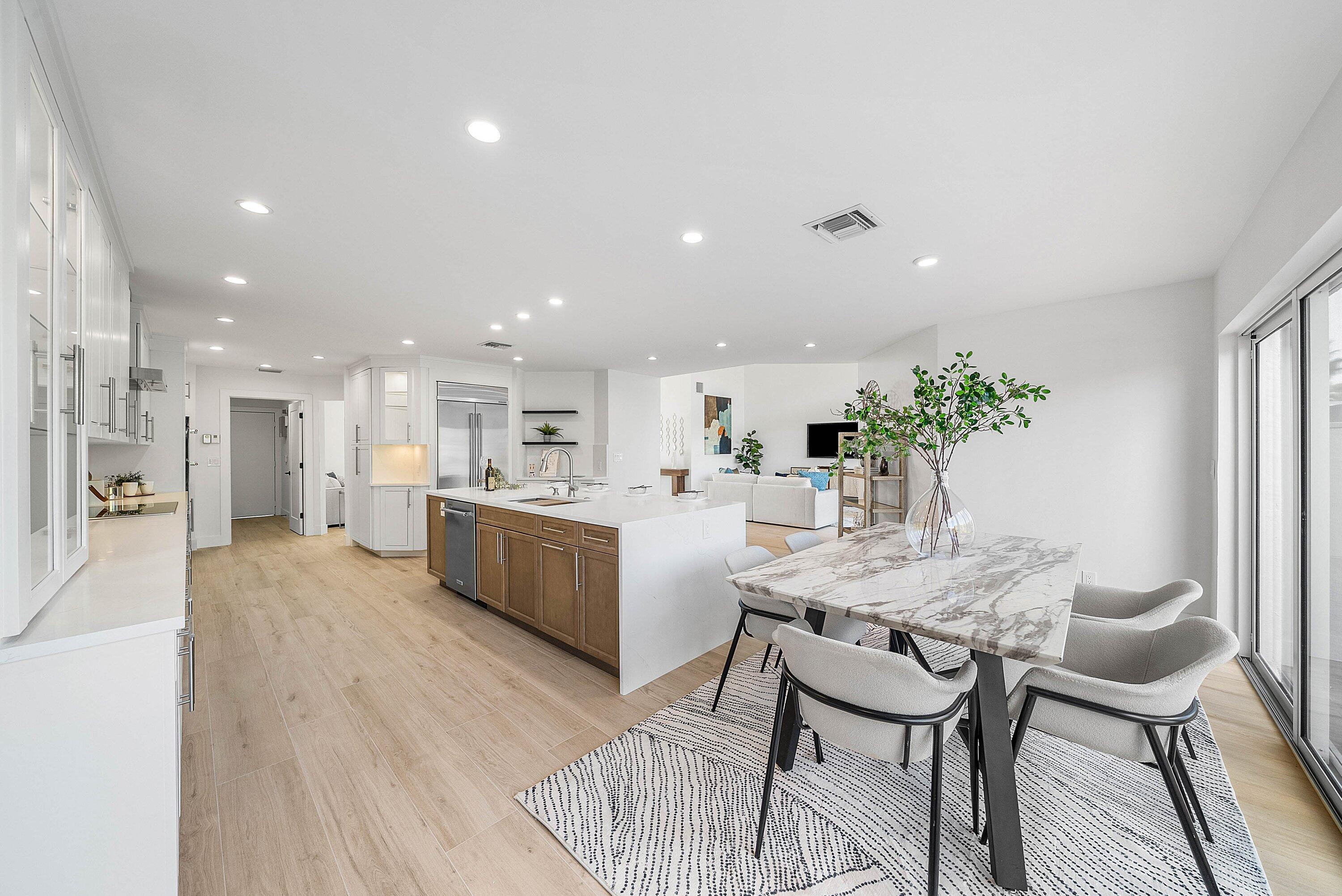 5174 Windsor Parke Drive Boca Raton, FL 33496 - Photo 8 of 55 a kitchen with a table and chairs in it