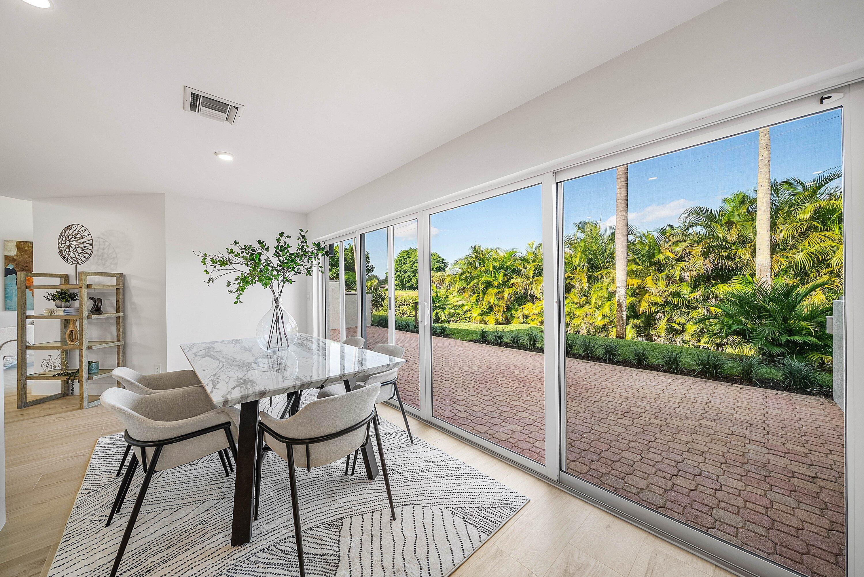 5174 Windsor Parke Drive Boca Raton, FL 33496 - Photo 9 of 55 a dining room with furniture and a floor to ceiling window