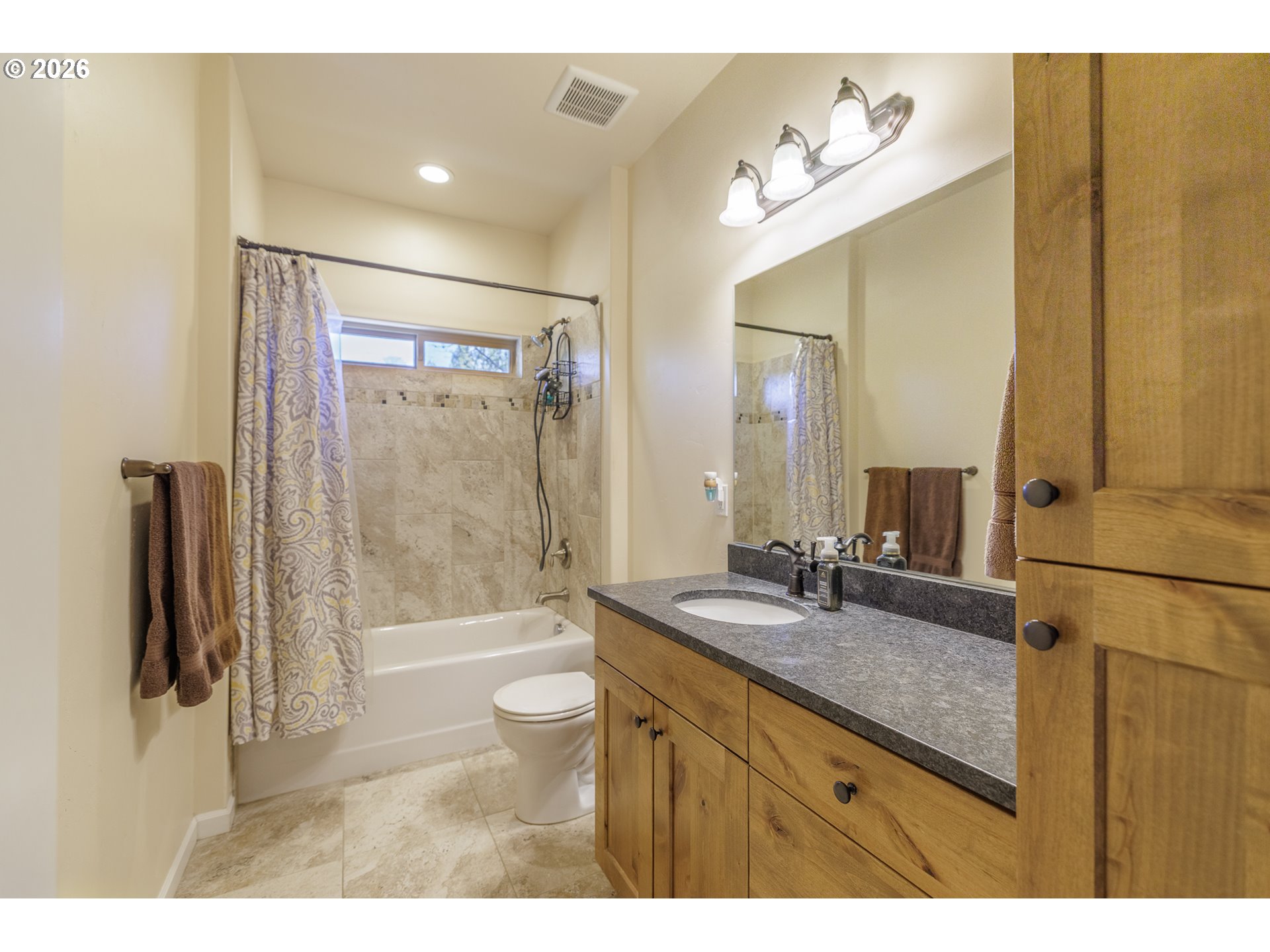 16802 Pony Express Way Bend, OR 97707 - Photo 19 of 37 a bathroom with a sink a toilet and a large mirror