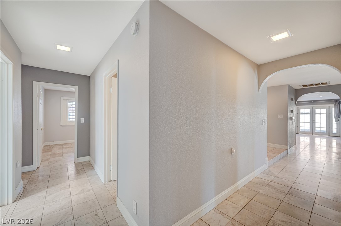 6635 Costa Brava Road Las Vegas, NV 89146 - Photo 36 of 59 An inviting passageway features arched doorways and pristine tile flooring.
