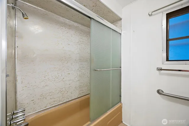 a bathroom with a bathtub and a shower