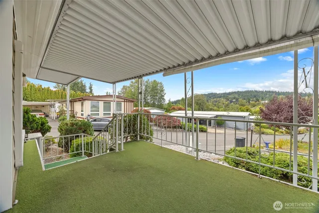 a view of a house with a big yard and potted plants