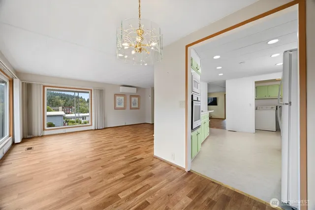 a view of livingroom with hardwood floor and a kitchen