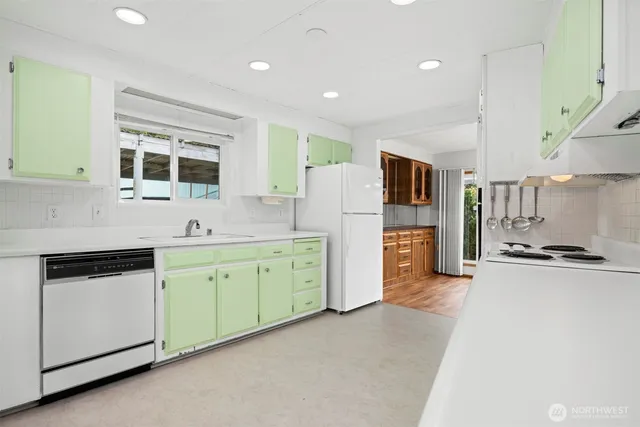 a kitchen with furniture a refrigerator and a stove
