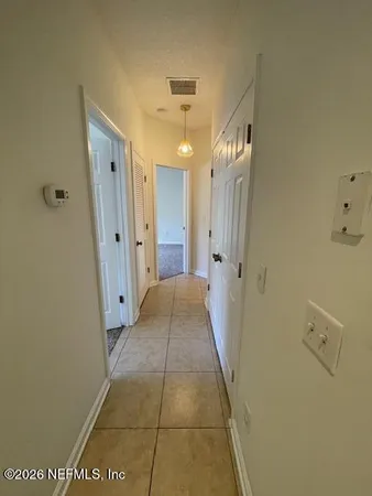 an empty room with a empty space and windows