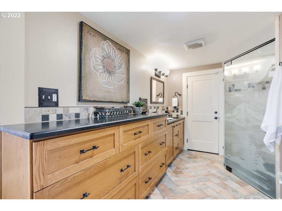 123 Shirley Street Molalla, OR 97038 - Photo 20 of 32 a bathroom with a granite countertop double vanity sink a mirror a shower and bathtub