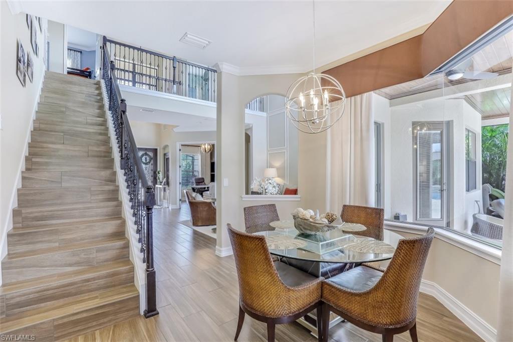 3289 Runaway Lane Naples, FL 34114 - Photo 15 of 35 a view of a dining room with furniture and wooden floor