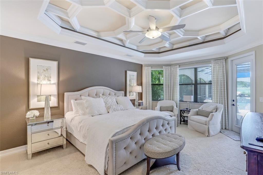 3289 Runaway Lane Naples, FL 34114 - Photo 18 of 35 a bedroom with a large bed and a chandelier