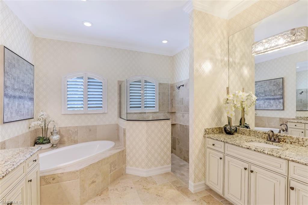 3289 Runaway Lane Naples, FL 34114 - Photo 19 of 35 a bathroom with a granite countertop tub sink and mirror