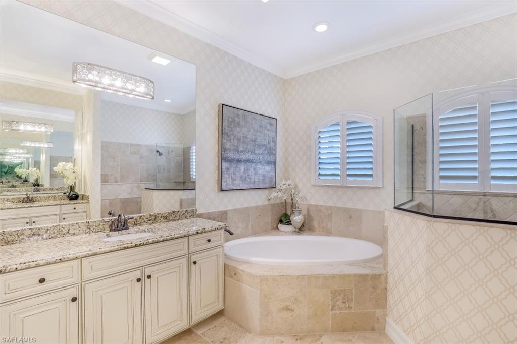 3289 Runaway Lane Naples, FL 34114 - Photo 20 of 35 a bathroom with a granite countertop sink a large mirror a bathtub and next to a window