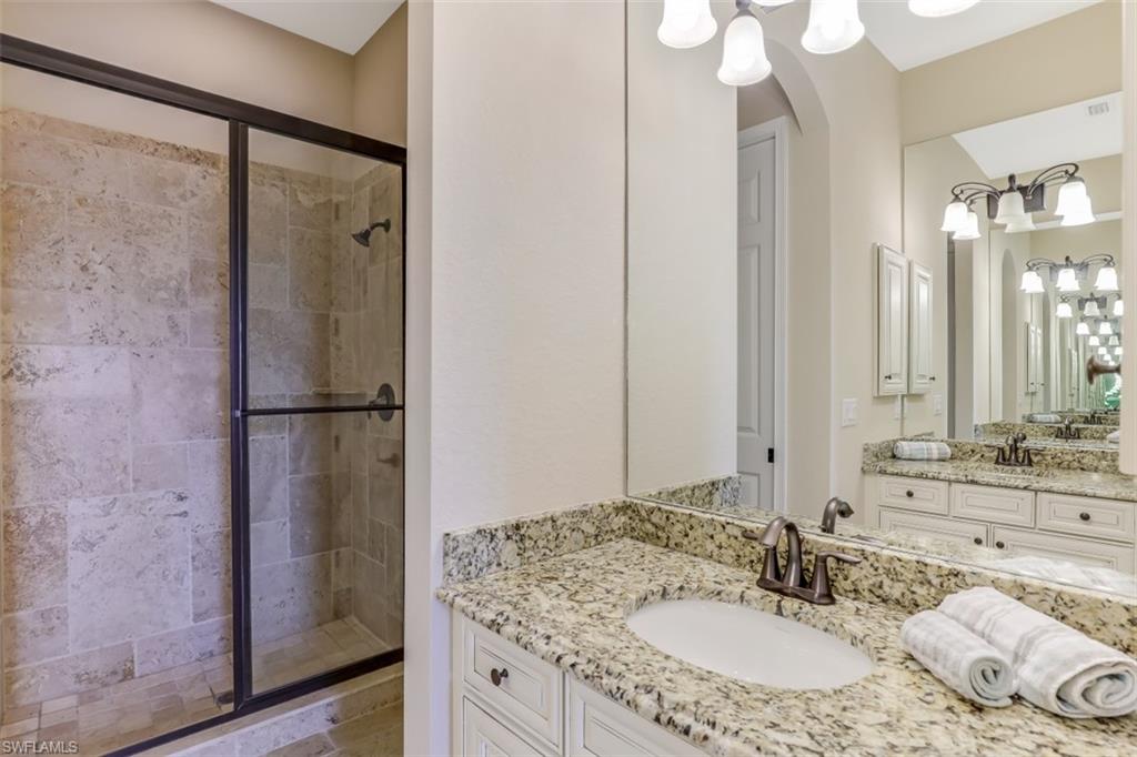 3289 Runaway Lane Naples, FL 34114 - Photo 22 of 35 a bathroom with a sink and a mirror