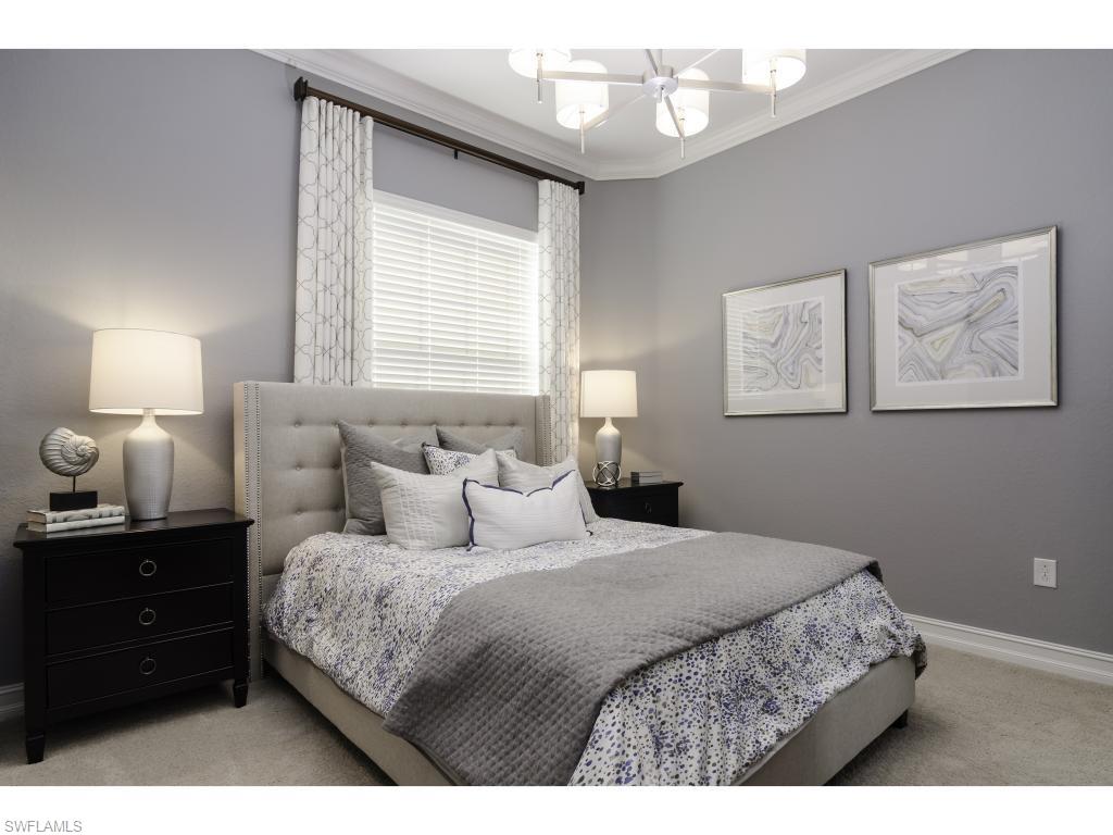 3289 Runaway Lane Naples, FL 34114 - Photo 23 of 35 a bedroom with a bed and a lamp
