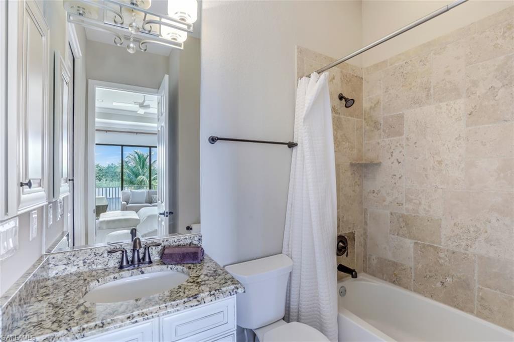 3289 Runaway Lane Naples, FL 34114 - Photo 25 of 35 a bathroom with a granite countertop bathtub shower sink vanity and a toilet
