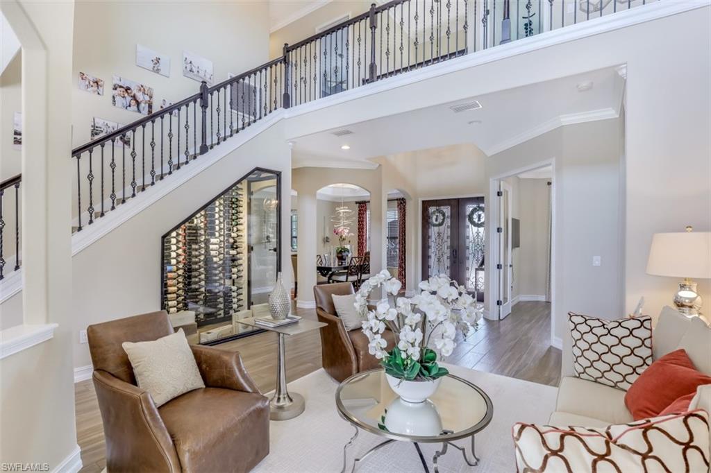 3289 Runaway Lane Naples, FL 34114 - Photo 7 of 35 a living room with furniture and a chandelier