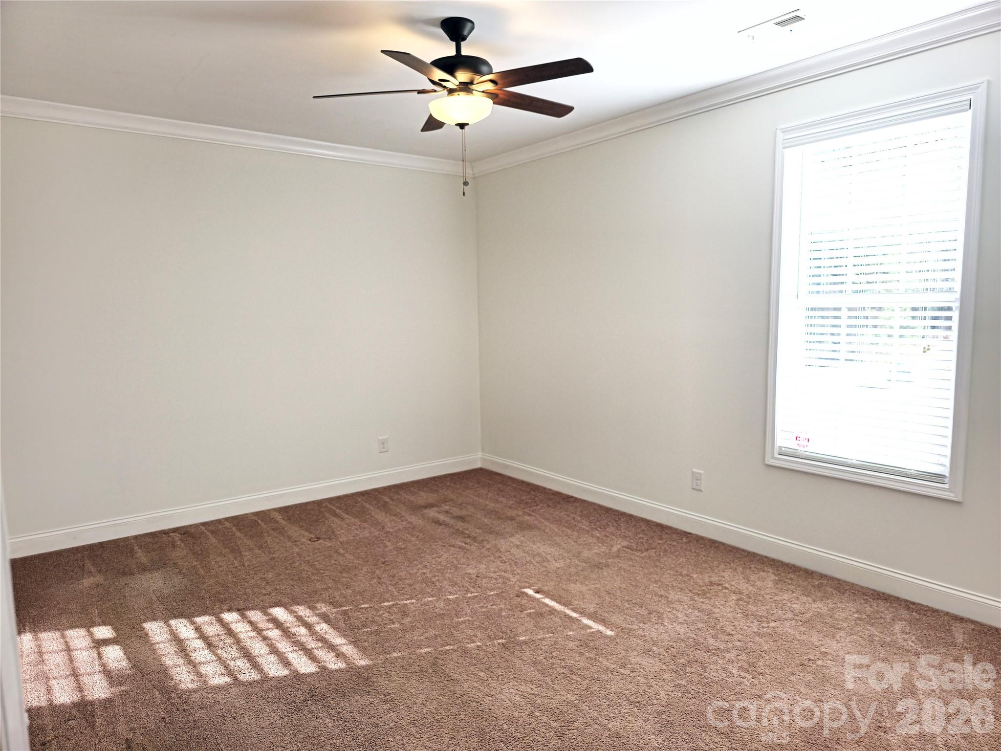 4607 Nesbit Road Monroe, NC 28112 - Photo 16 of 30 an empty room with a window and a fan
