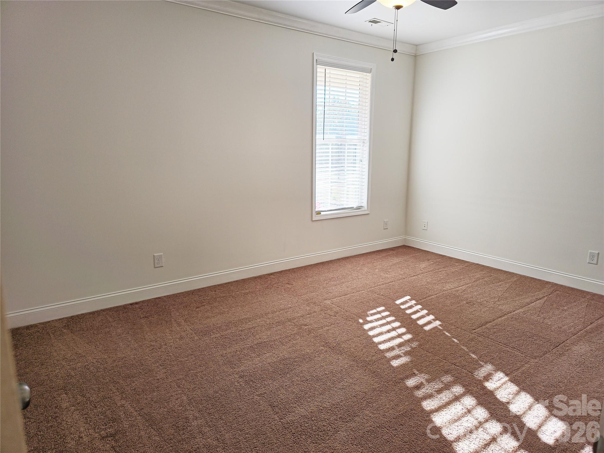 4607 Nesbit Road Monroe, NC 28112 - Photo 18 of 30 an empty room with windows and chandelier fan