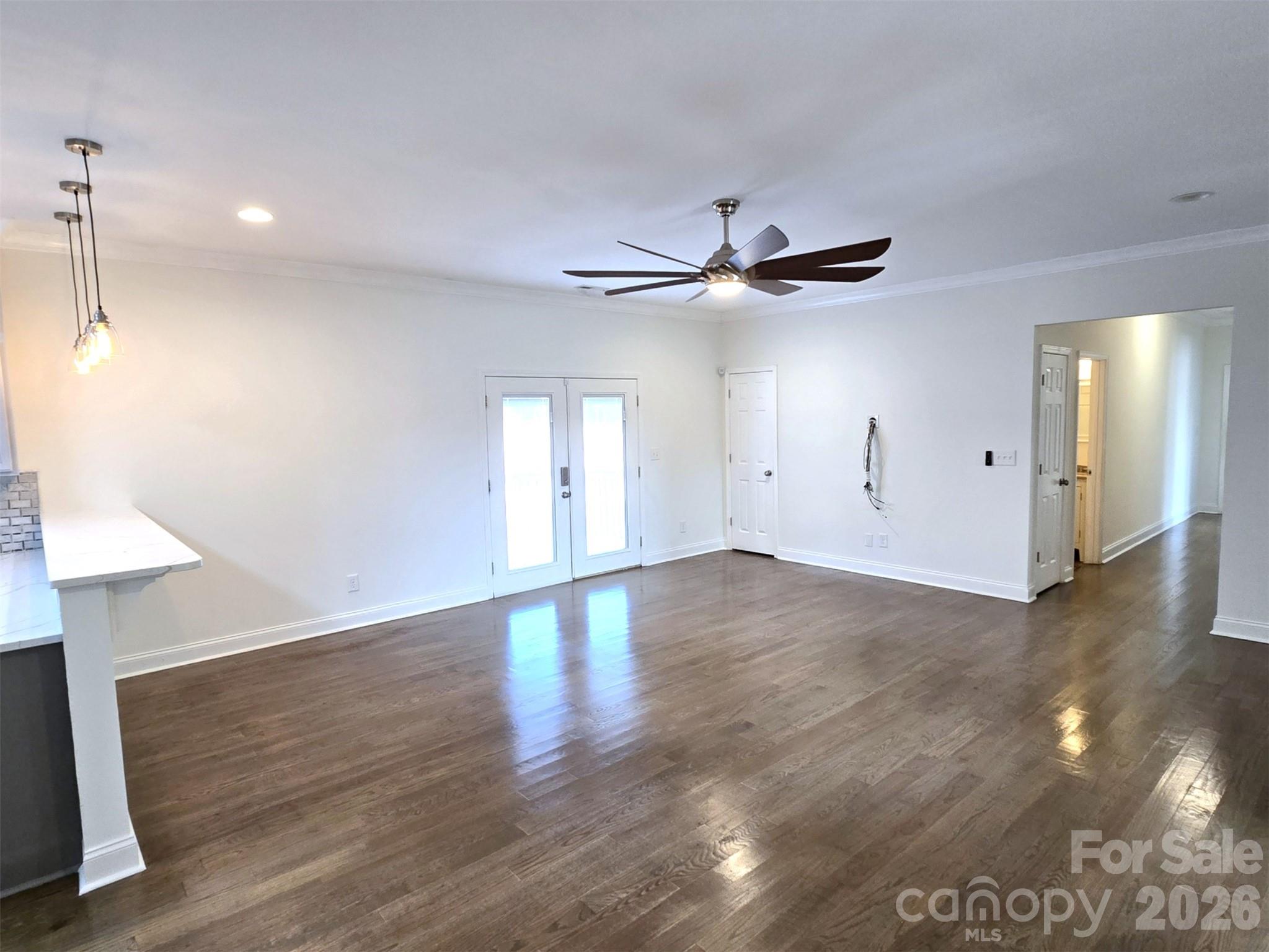4607 Nesbit Road Monroe, NC 28112 - Photo 5 of 30 a view of an empty room with wooden floor and a ceiling fan