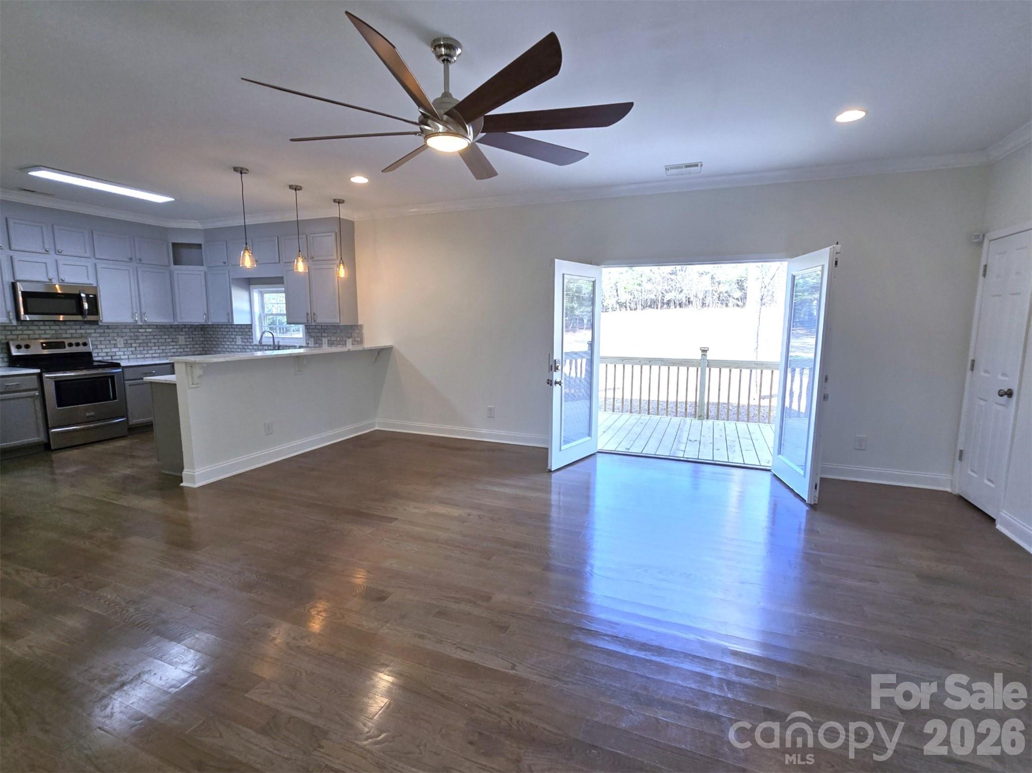 4607 Nesbit Road Monroe, NC 28112 - Photo 10 of 30 a view of kitchen with stainless steel appliances granite countertop a stove top oven a sink with wooden floors and white walls