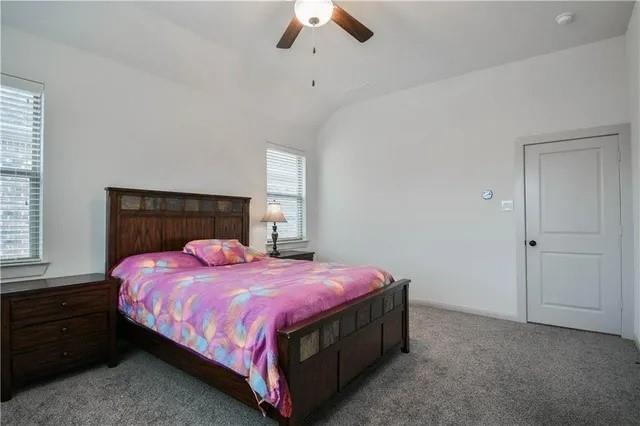 1402 French Violet Way Arlington, TX 76005 - Photo 19 of 29 a bedroom with a bed and a ceiling fan
