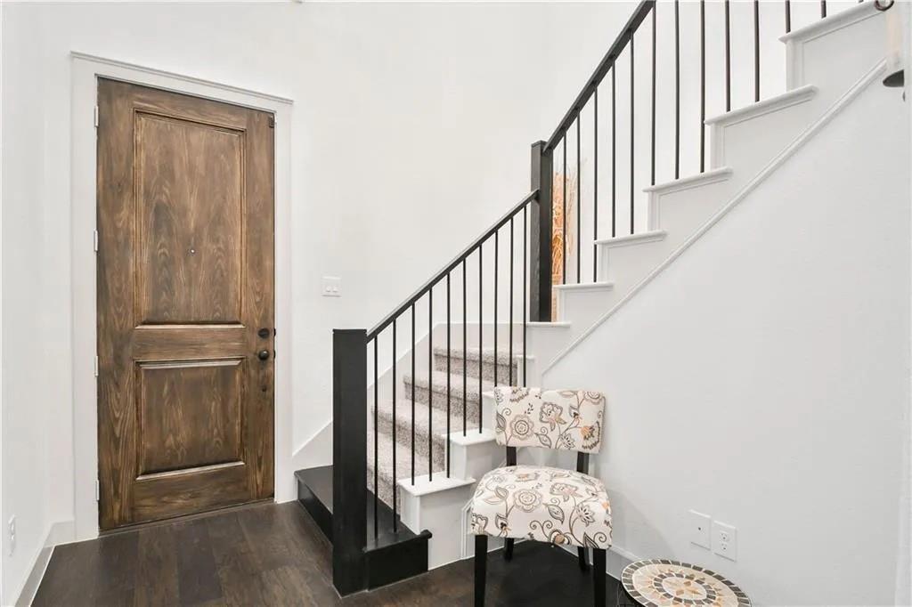 1402 French Violet Way Arlington, TX 76005 - Photo 20 of 29 a view of a hallway with wooden floor and entryway