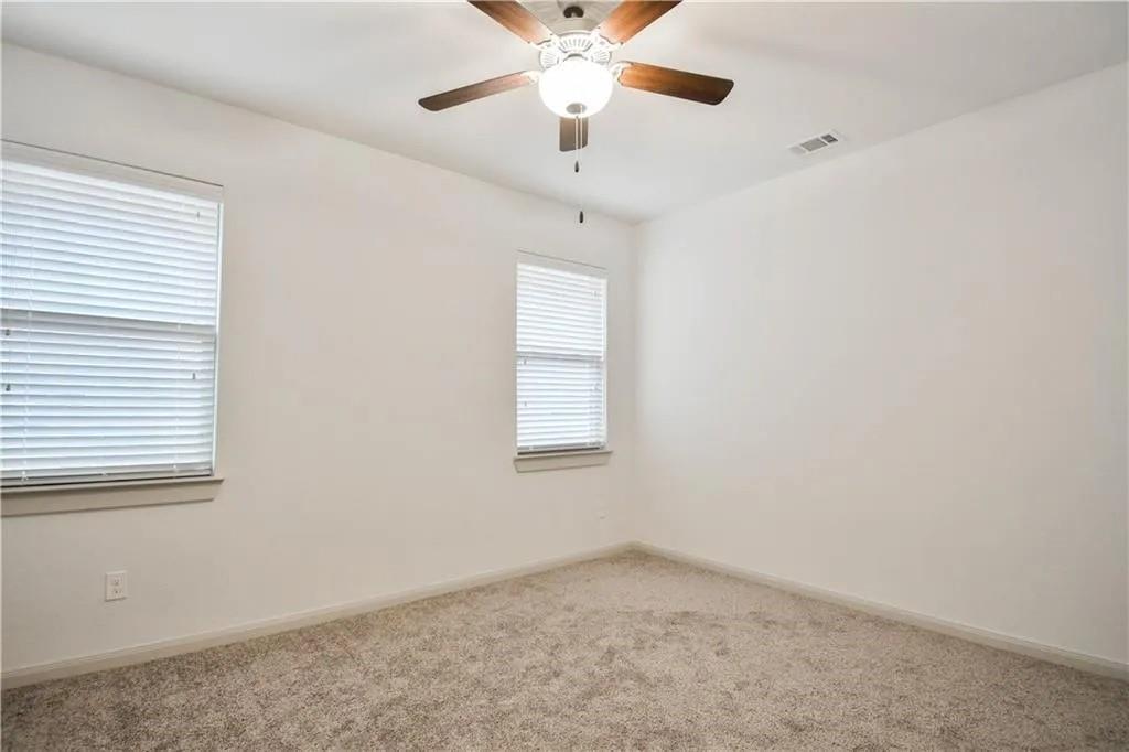 1402 French Violet Way Arlington, TX 76005 - Photo 27 of 29 an empty room with a window and a ceiling fan
