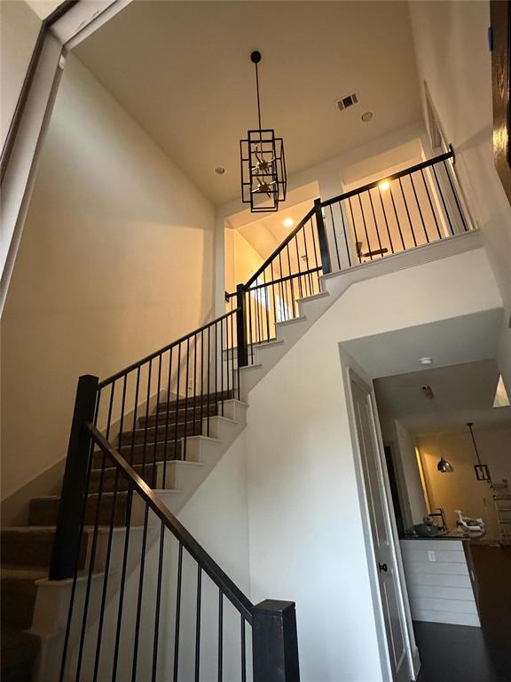1402 French Violet Way Arlington, TX 76005 - Photo 29 of 29 a view of staircase with railing and a chandelier
