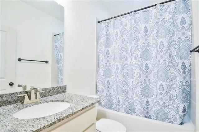 1402 French Violet Way Arlington, TX 76005 - Photo 8 of 29 a bathroom with a granite countertop sink and a mirror