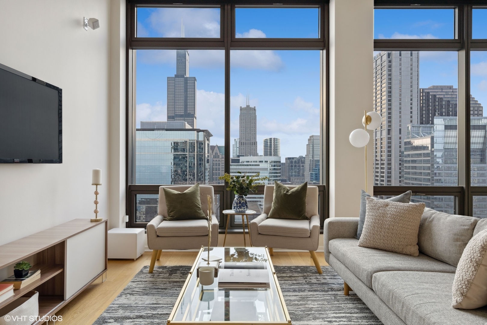 65 East Monroe Street, Unit 4217 Chicago, IL 60603 - Photo 2 of 27 a living room with furniture and a flat screen tv