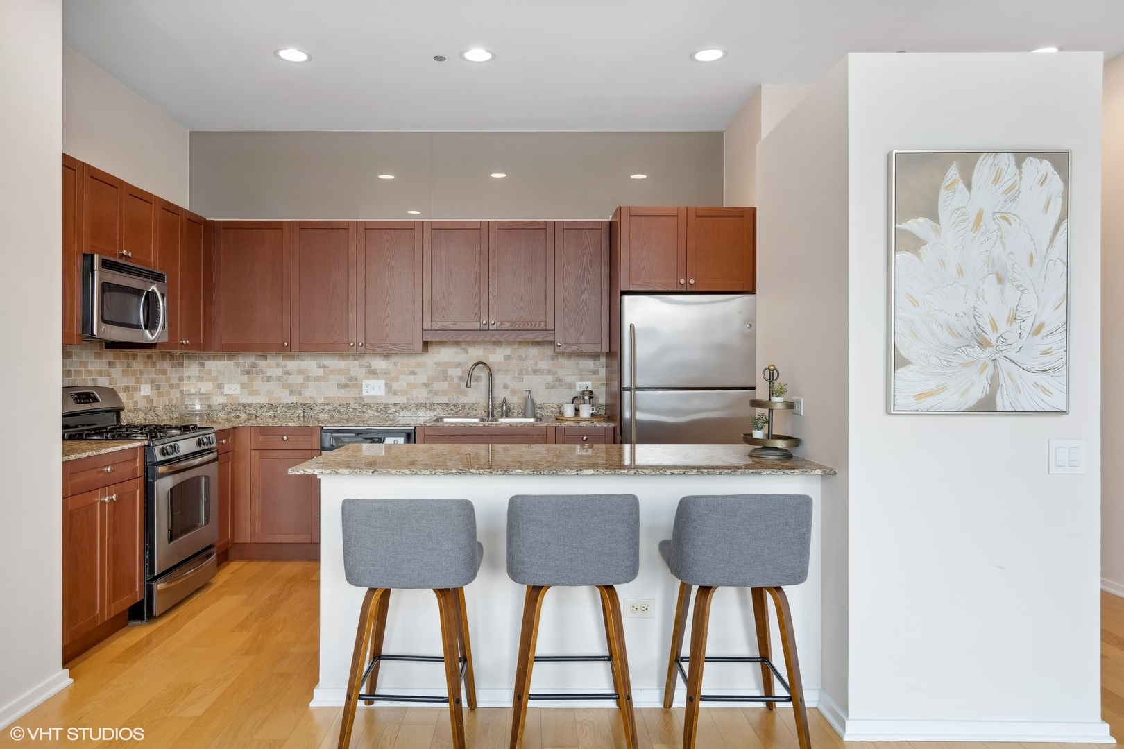 65 East Monroe Street, Unit 4217 Chicago, IL 60603 - Photo 6 of 27 a kitchen with stainless steel appliances granite countertop a stove top oven a sink and a refrigerator