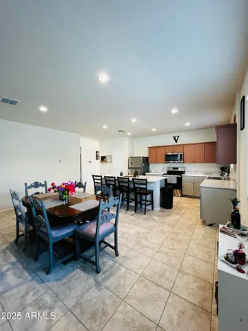 a kitchen with a dining table and chairs