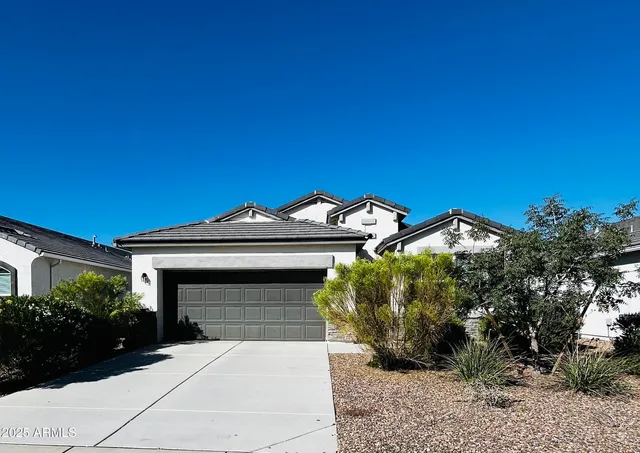 a front view of a house with a garden