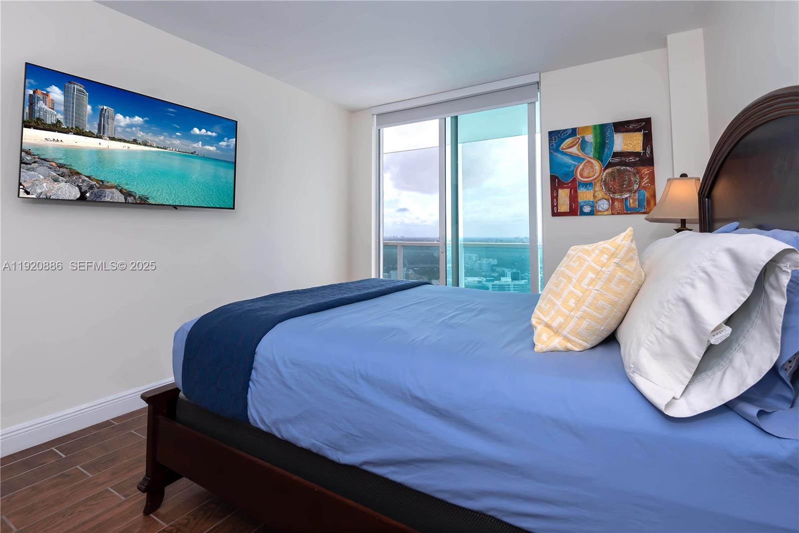 1250 South Miami Avenue, Unit 3205 Miami, FL 33130 - Photo 12 of 36 a bedroom with a bed and painting on the wall