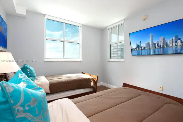 a bedroom with two beds and a window