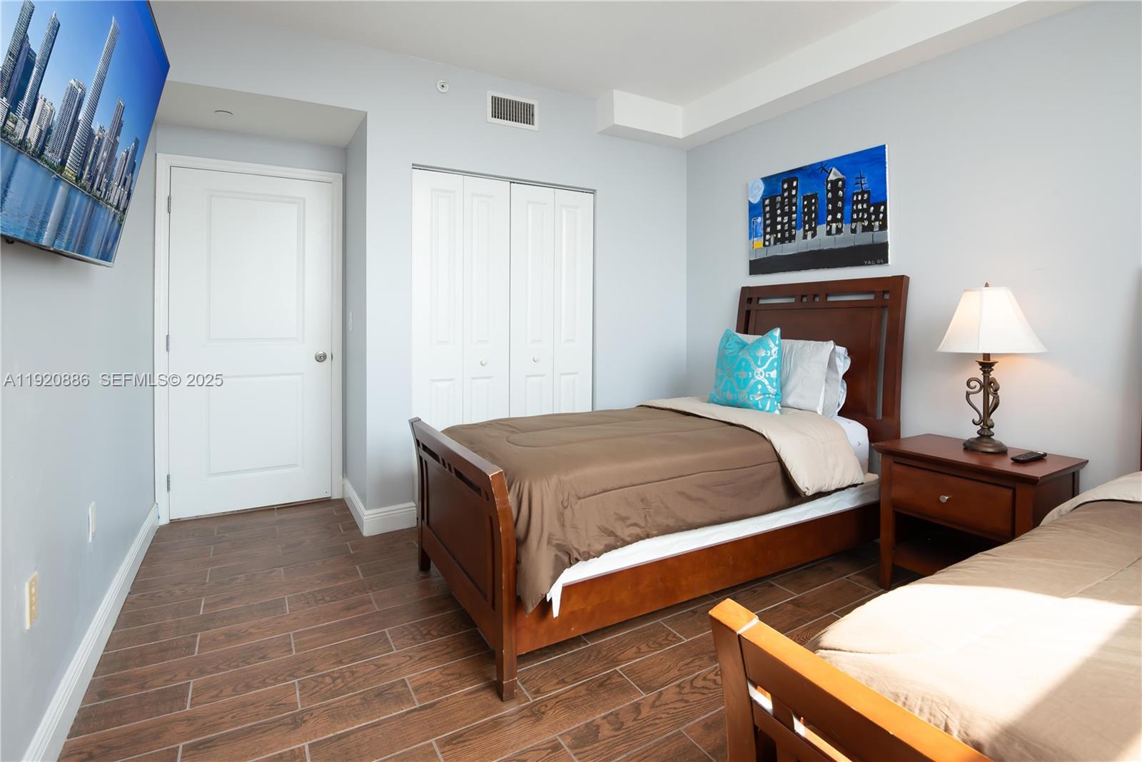 1250 South Miami Avenue, Unit 3205 Miami, FL 33130 - Photo 17 of 36 a bedroom with a bed and a lamp on table