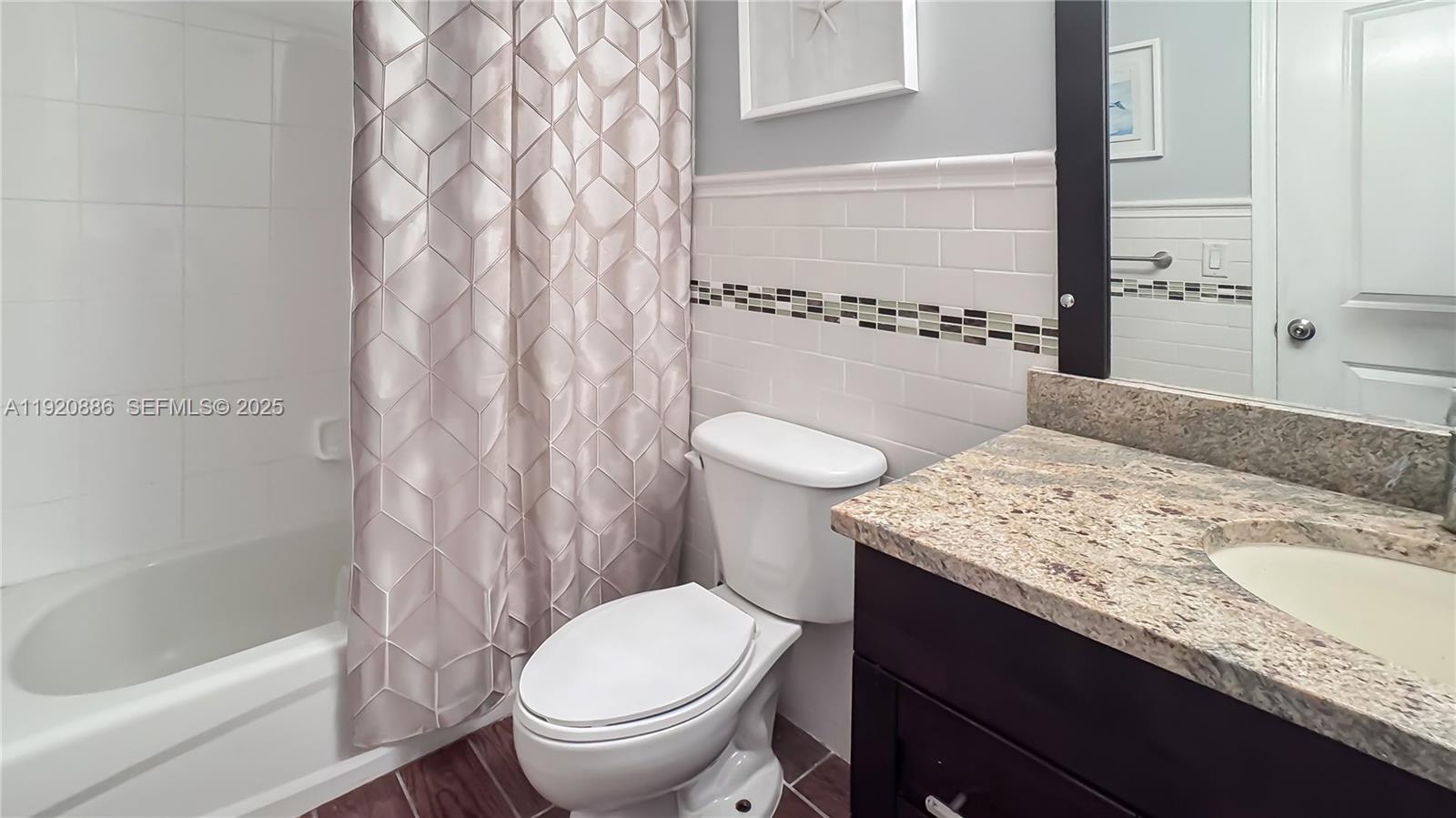 1250 South Miami Avenue, Unit 3205 Miami, FL 33130 - Photo 18 of 36 a bathroom with a granite countertop sink toilet and shower