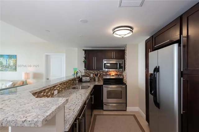 a kitchen with a refrigerator sink and stove