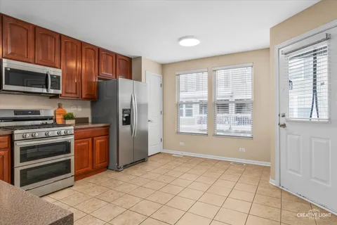 a kitchen with stainless steel appliances granite countertop a refrigerator oven a sink dishwasher and granite countertops