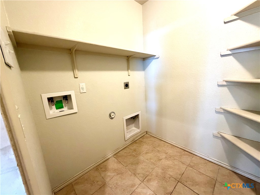 500 Obsidian Lane Jarrell, TX 76537 - Photo 14 of 33 a view of kitchen and utility room