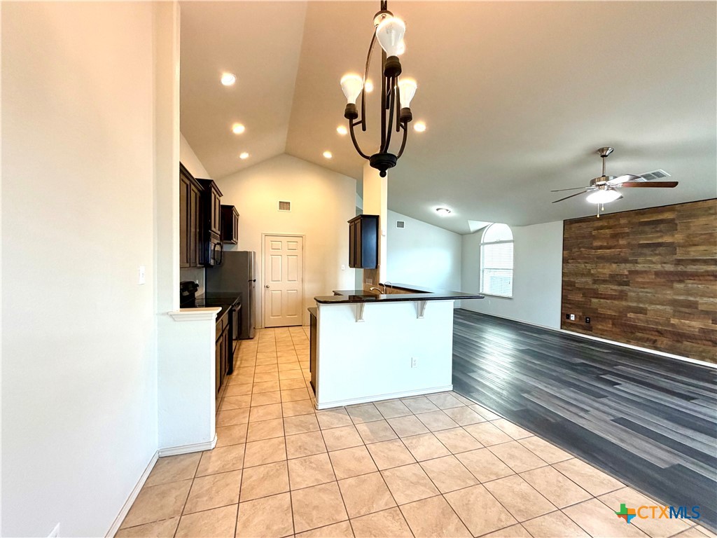 500 Obsidian Lane Jarrell, TX 76537 - Photo 16 of 33 a view of a kitchen with flat screen tv and refrigerator