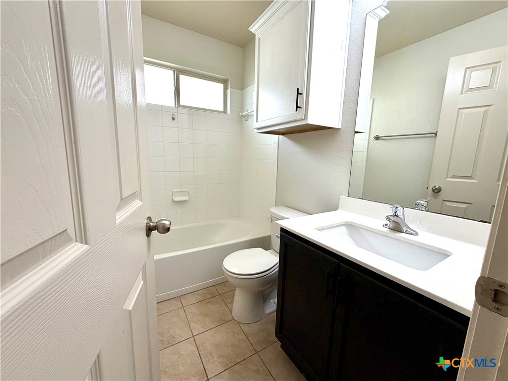500 Obsidian Lane Jarrell, TX 76537 - Photo 30 of 33 a bathroom with a sink a toilet and shower