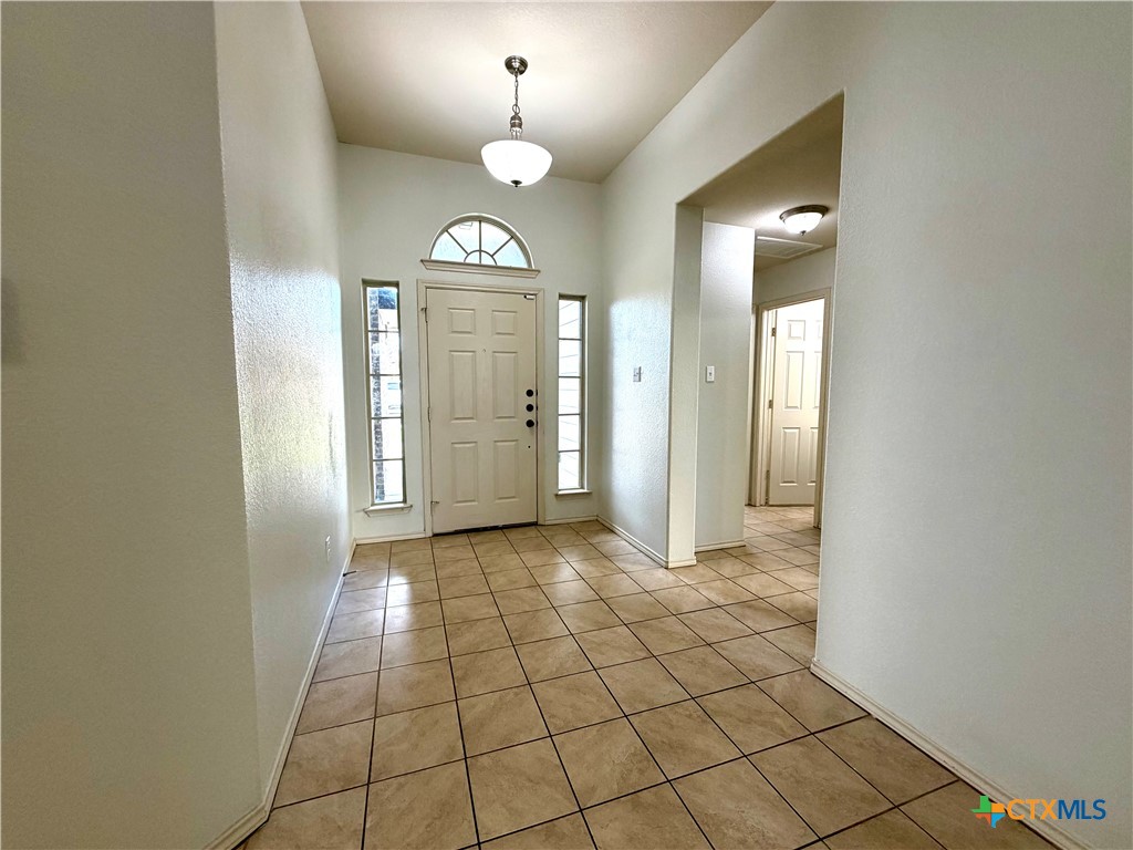 500 Obsidian Lane Jarrell, TX 76537 - Photo 4 of 33 a view of a hallway with wooden floor