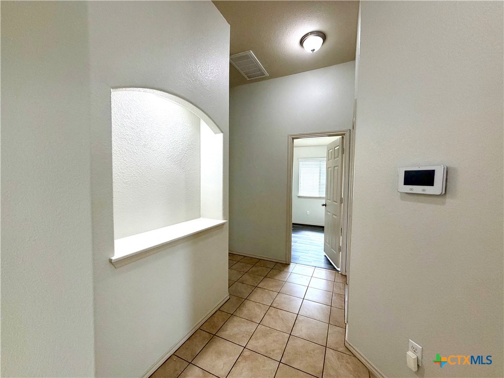 500 Obsidian Lane Jarrell, TX 76537 - Photo 6 of 33 a view of a hallway with wooden floor and a bathroom