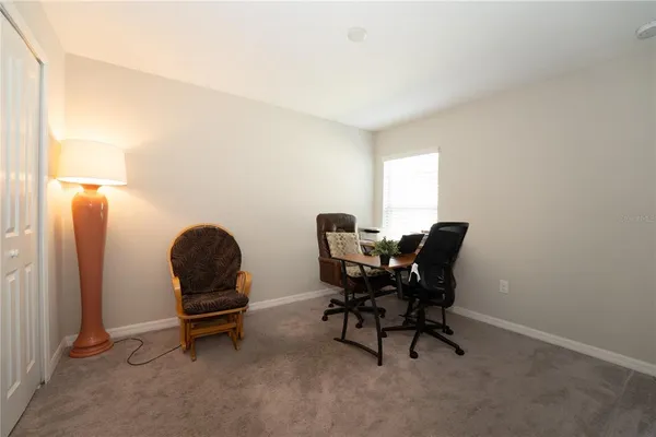 a view of a workspace with furniture and a window