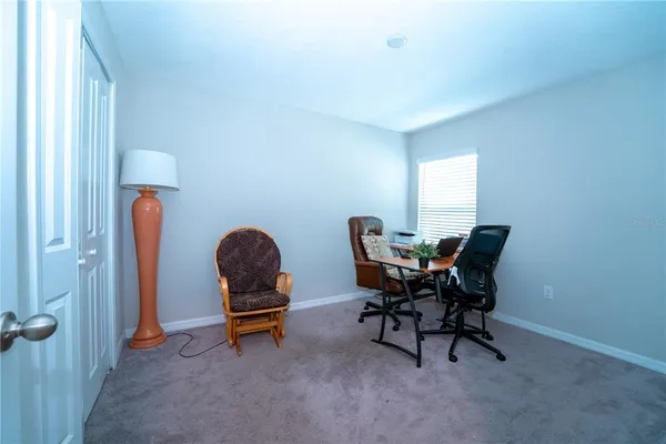 a bedroom with a bed and a ceiling fan