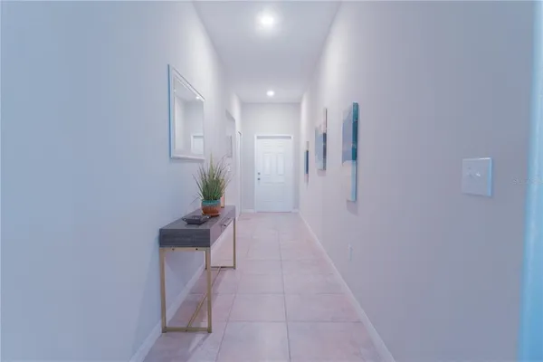 a hallway with a potted plant