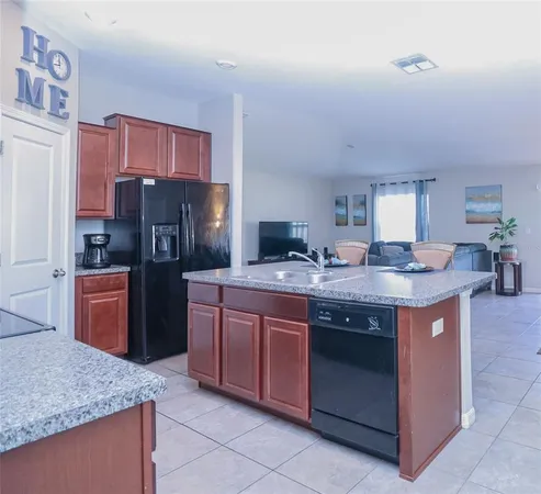 a kitchen with large cabinets a sink and stainless steel appliances