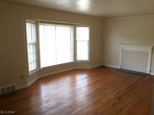 3597 Normandy Road Cleveland, OH 44120 - Photo 14 of 26 Spare room featuring dark hardwood / wood-style flooring and a wealth of natural light