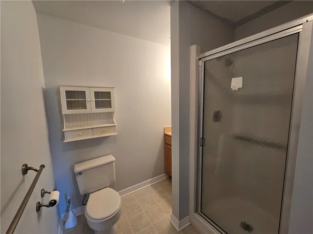 a white toilet sitting next to a bathroom sink